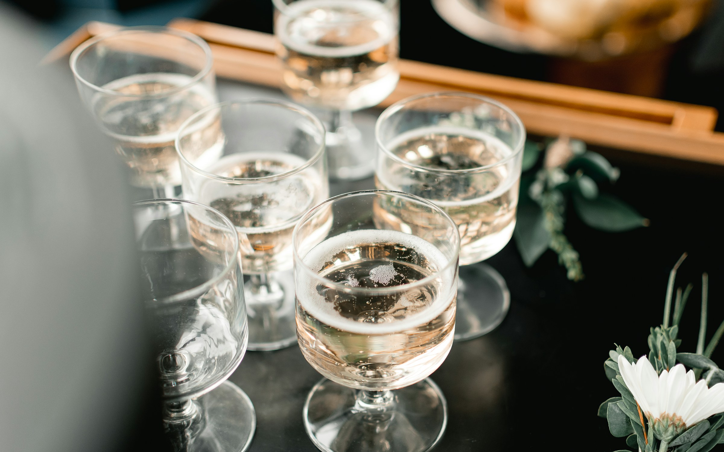 Bubbly cocktails atop wedding reception bar for bridal party