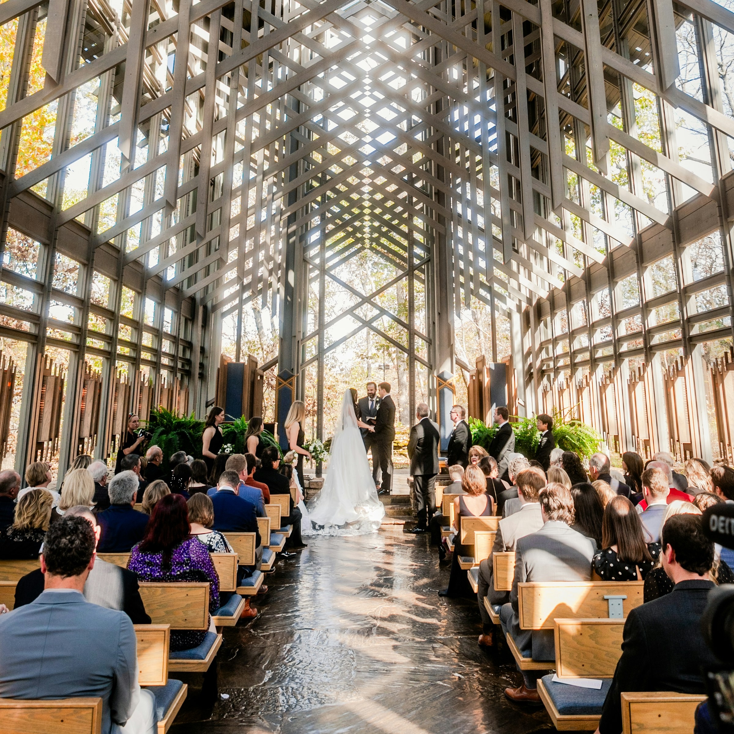 Wedding ceremony indoors with guests observing in modern design venue