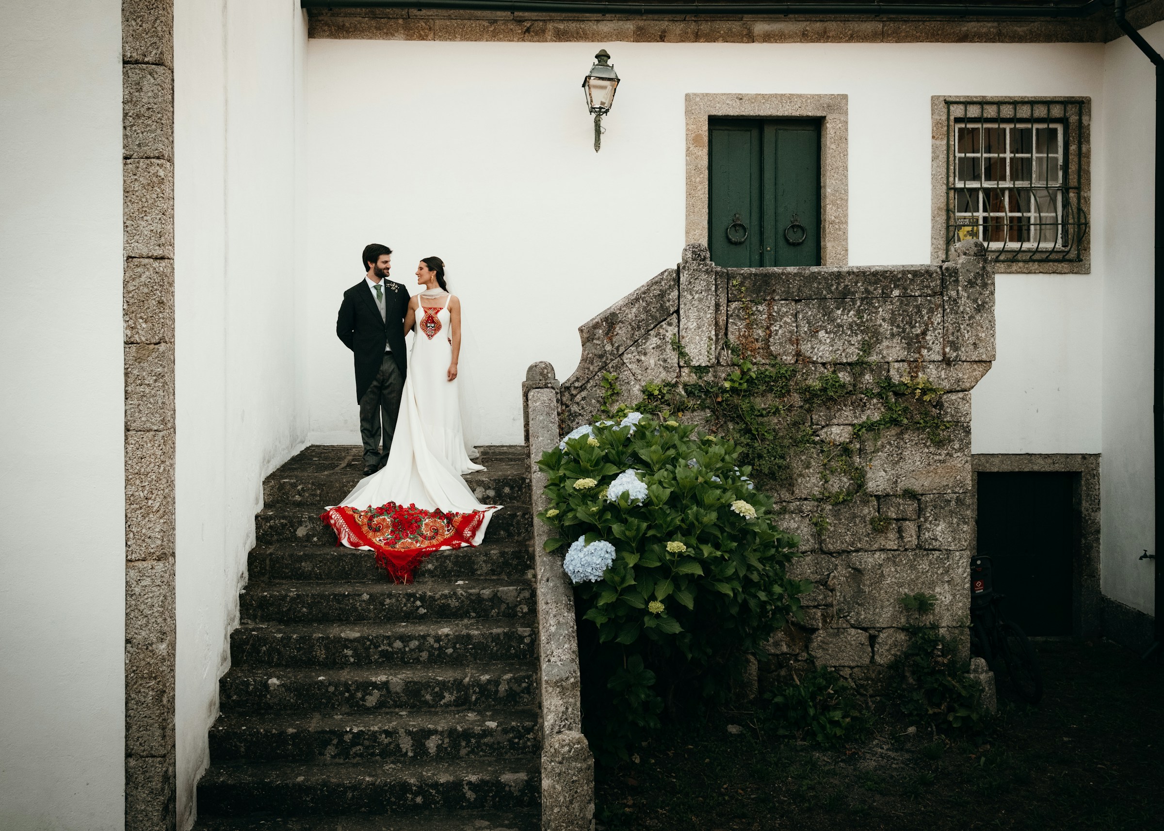 Bride and groom on old stone staircase in Porto wedding venue